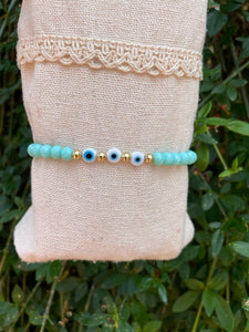 Bracelet élastique en perles de verre à facettes forme Oblate et Oeil Nazar Boncuk